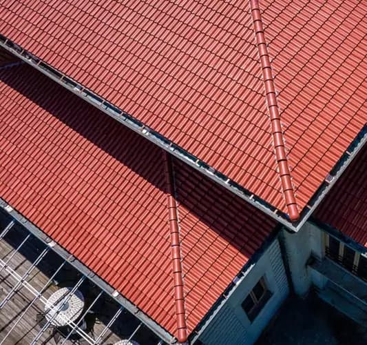 An aging composite Spanish tile roof showing signs of wear