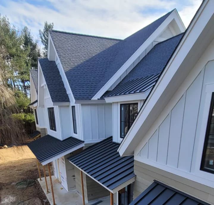 Roofers installing wind-rated asphalt shingles on a home near the Throgs Neck waterfront in the Bronx